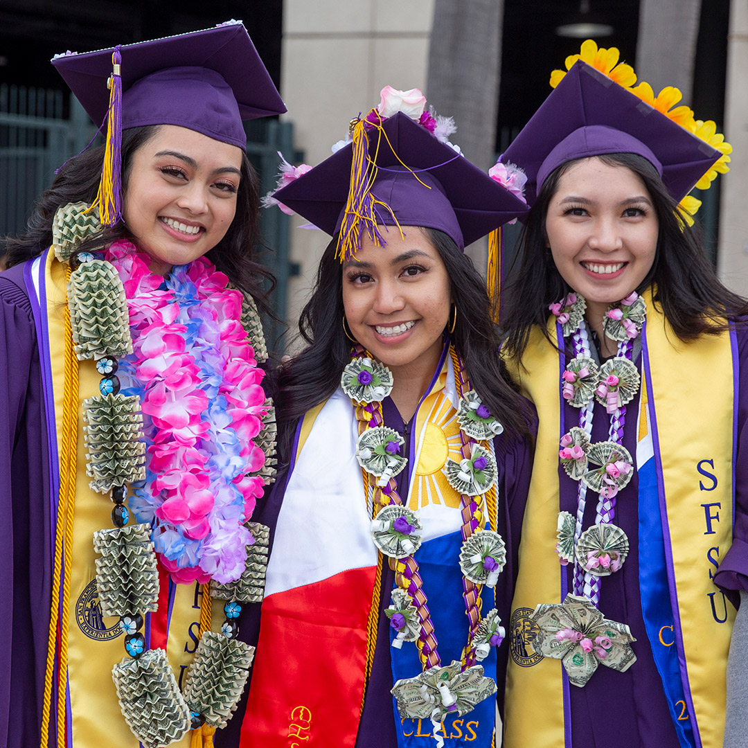 Business graduates wearing money leis at Commencement