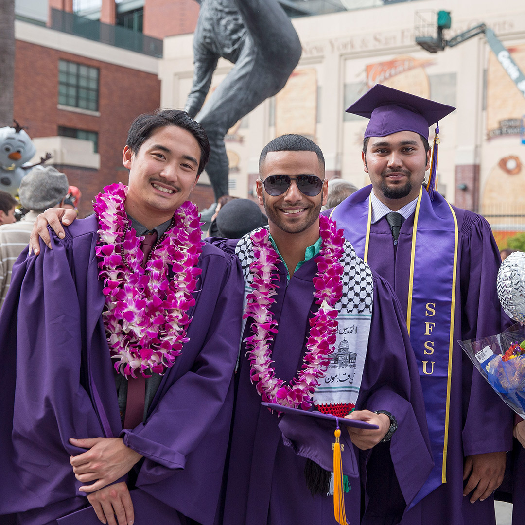 Three new graduates at Commencement