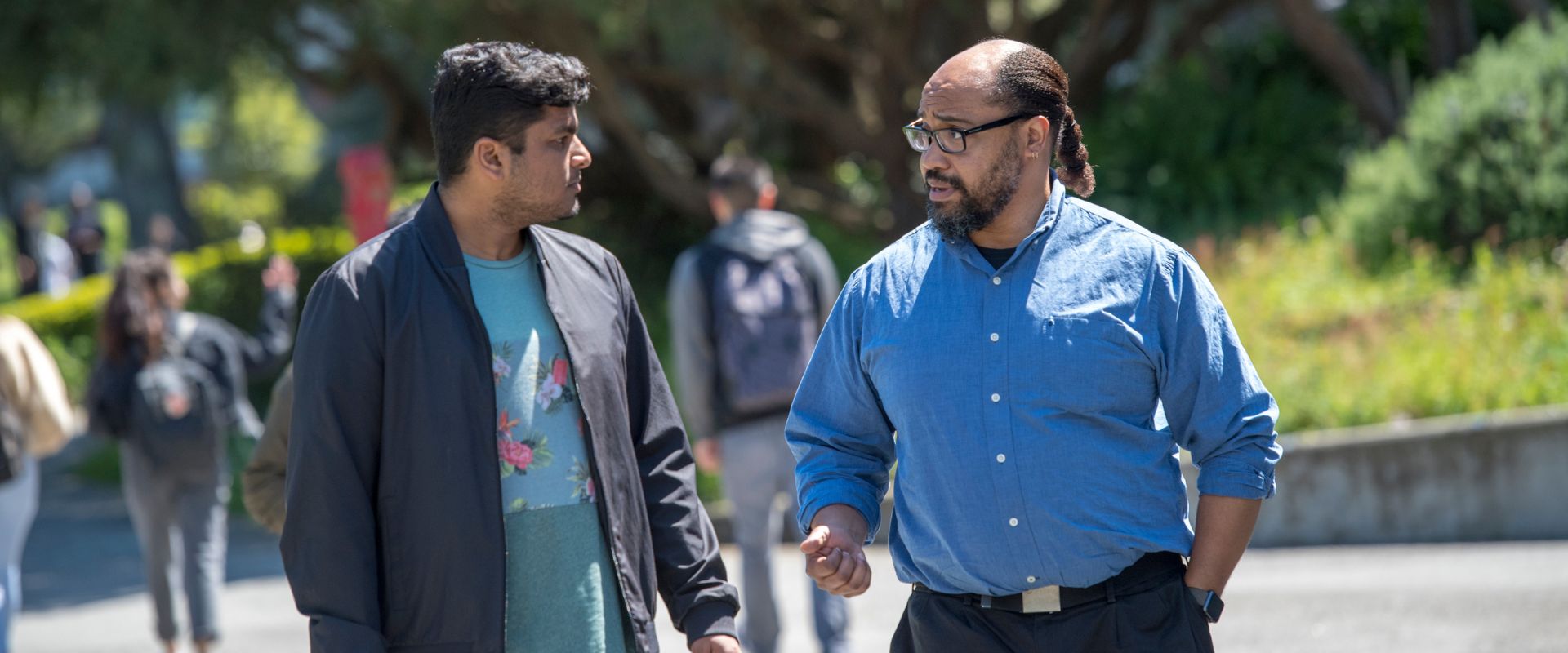 Two Ethnic Studies teachers walking and talking on campus
