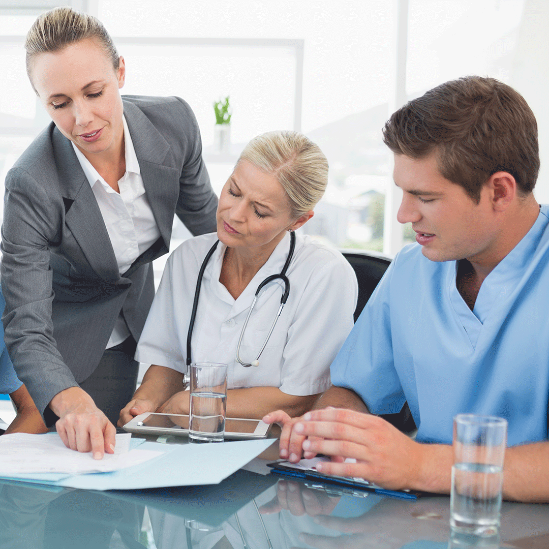 Medical billing professional discussing bill with doctors