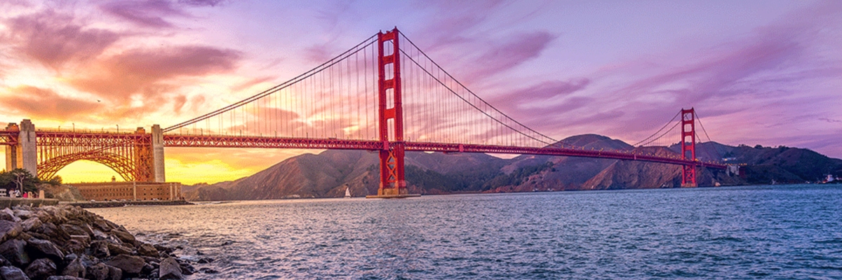 San Francisco's Golden Gate Bridge, with a purple and gold sunset sky