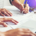 Construction Professionals work with plans and laptop