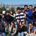 International students at Dolores Park, with a cityscape behind them