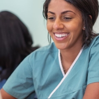 Medical assistant students in class look at computer