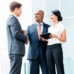 International businesspeople standing and shaking hands