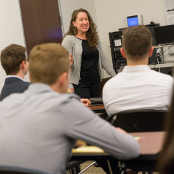 Business teacher smiles while teaching class