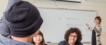 Student raises hand in class and teacher calls on him