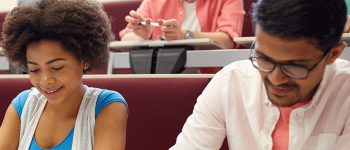 Students take a test in a lecture hall